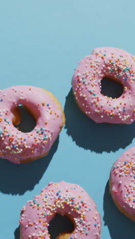 video of donuts with icing on blue background