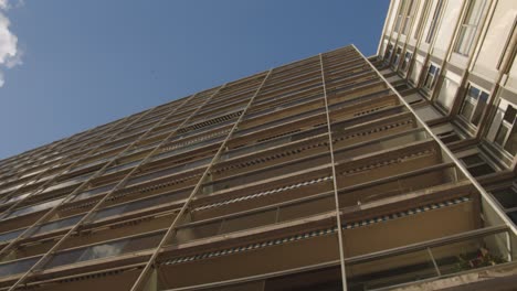 Looking-Up-On-The-Facade-Exterior-Of-An-Apartment-Buiding-During-Sunny-Day