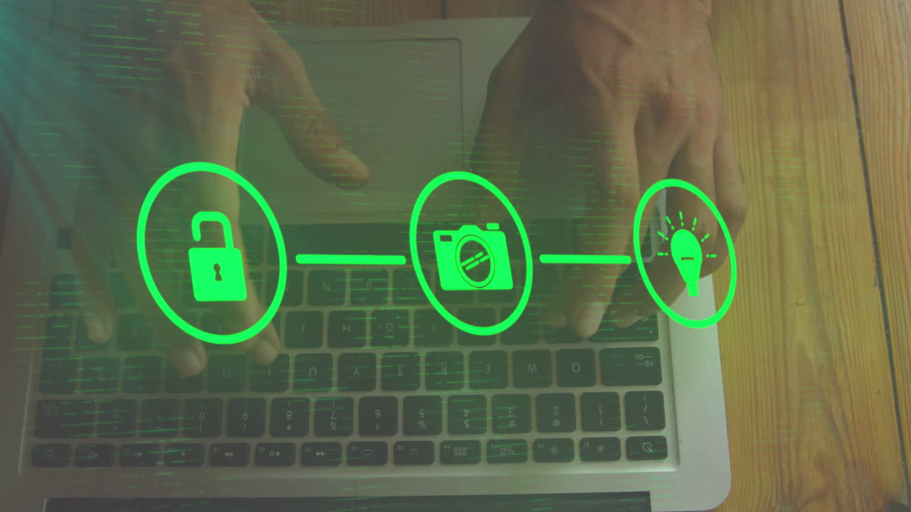 animación de iconos conectados, vista aérea de un hombre biracial escribiendo en el teclado de una computadora portátil