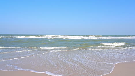The-waves-spread-out-along-a-sandy-beach
