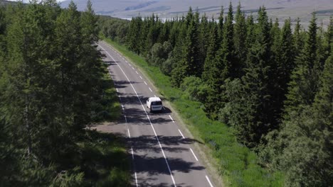 car driving through beautiful woodland landscape in natural iceland, aerial