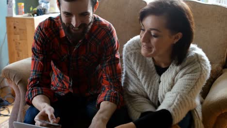 couple shopping online on laptop in living room