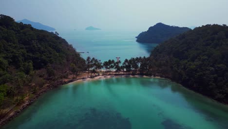 scenic aerial view of lush green hills and turquoise waters on koh chang ngam island. magic aerial view flight fly reverse drone