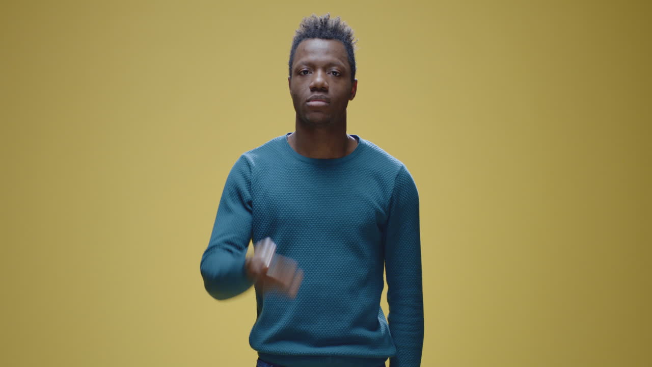 A man covers his mouth, indicating silence or a secret