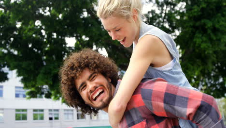 Young-men-giving-piggyback-ride-to-woman