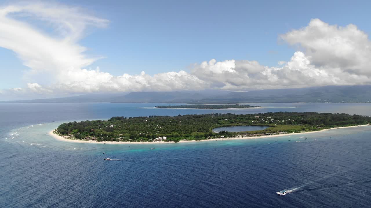 Aerial pullback showing Gili Meno's saltwater lake, Gili Air and Lombok in background