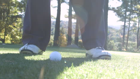 a man hits a golf ball off a tee in super slow motion