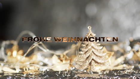 frohe weihnachten text in gold over christmas tree and decorations on grey bokeh background