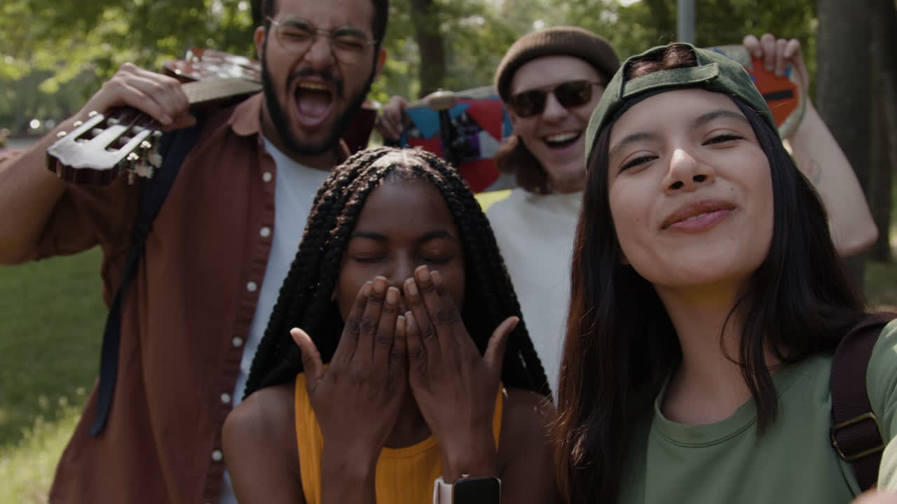Diverse group of friends smiling and laughing in a park