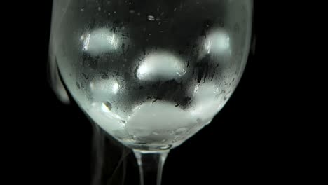 dry ice bubbling in a glass of champagne at black background