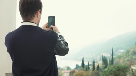 man taking photo of a scenic view