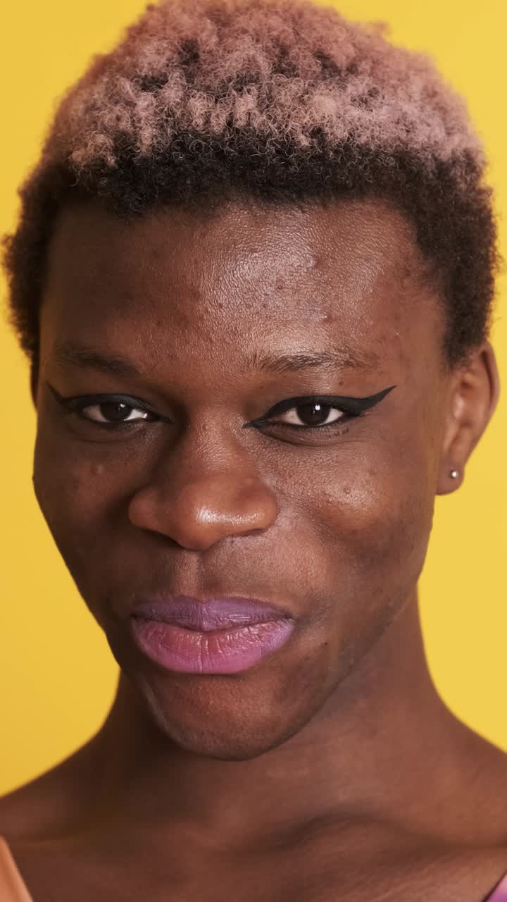 Two multiethnic transgender people looking at the camera with a serious ...