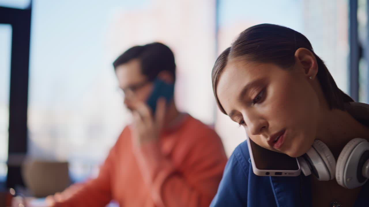 Telemarketing team talking smartphones at workplace closeup. Serious woman man