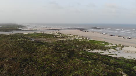 small movement towards the jetty, showing grass lands, dunes, ocean