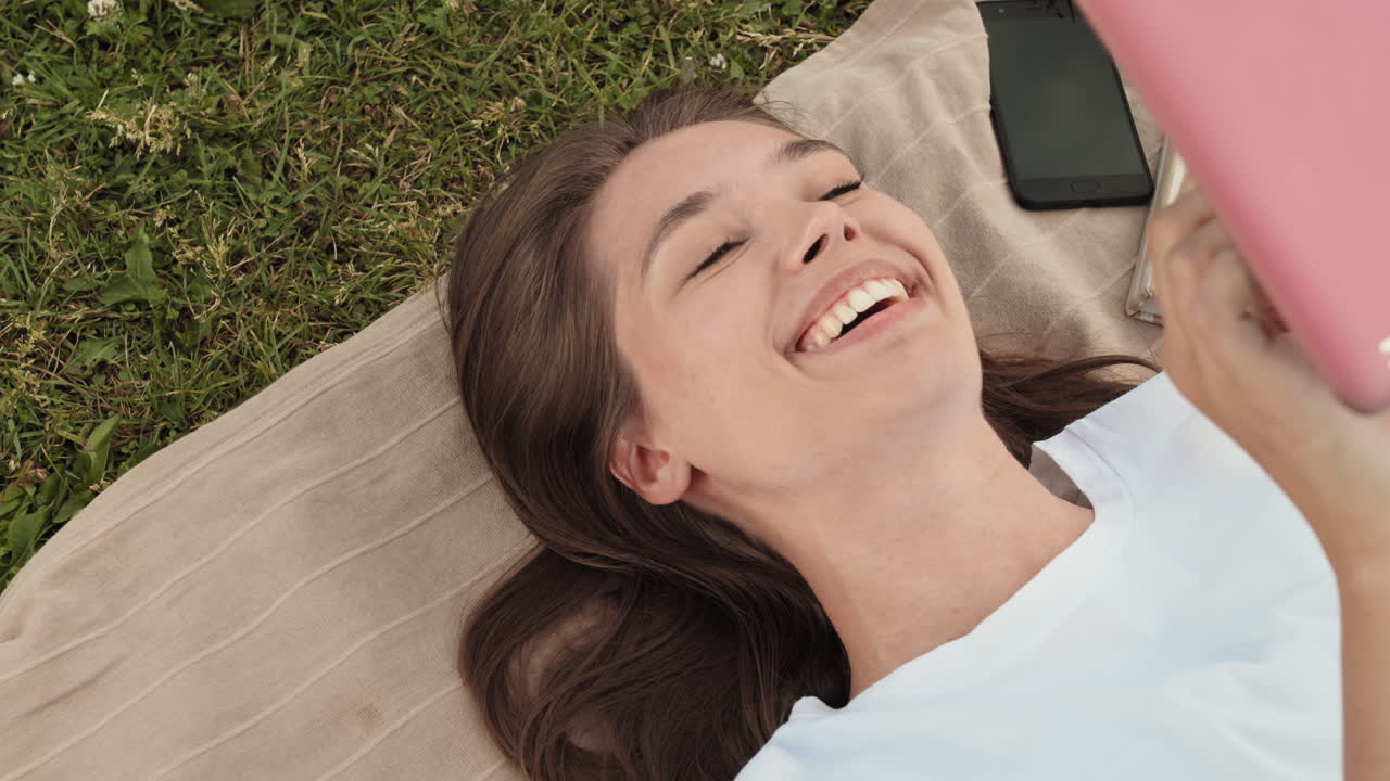 Woman Using Tablet Smiling Outdoors