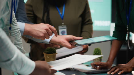 diverse business team exchanging insights and forecasting diagrams