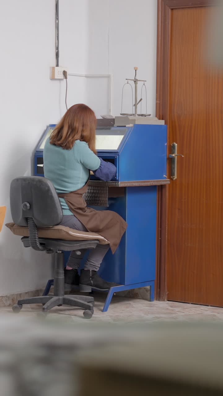 Woman working at a machine in a workshop