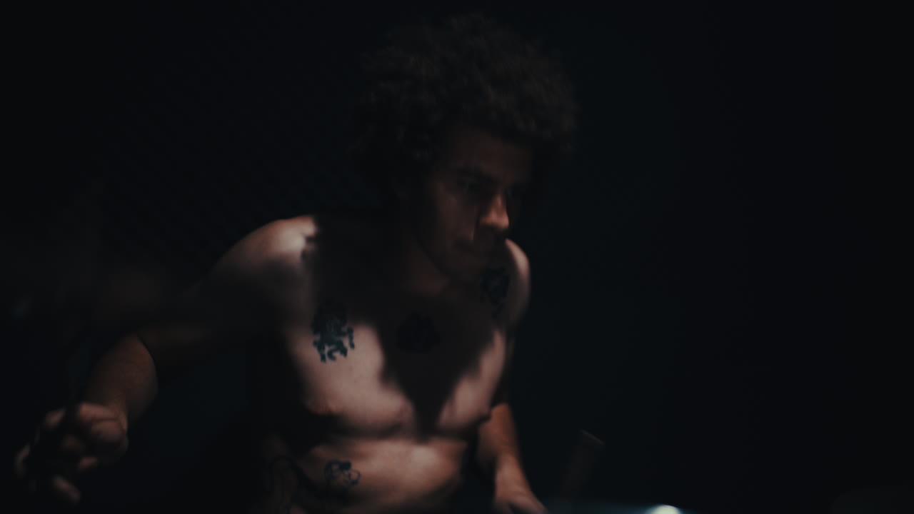 Shirtless Drummer in Low Light