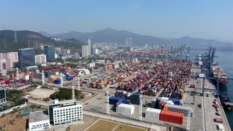 shenzhen commercial port terminal with docked ships and container yard, aerial view