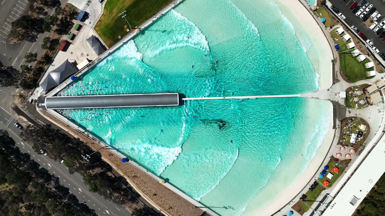 Aerial View of a Wave Pool with People Surfing