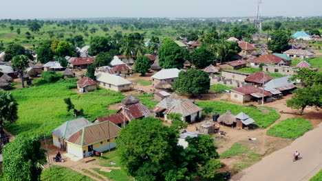 pila, nigeria rural community - pullback aerial flyover reveal