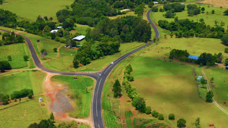 vehicle driving on countryside road among green fields in atherton tablelands, queensland, australia - hyperlapse