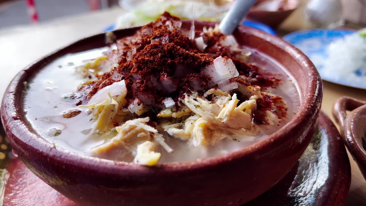 Bowl of white pozole, made with hominy, a classic Mexican dish for Independence Day