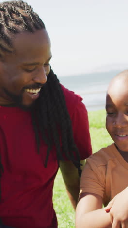 video of happy african american father and son having fun outdoors