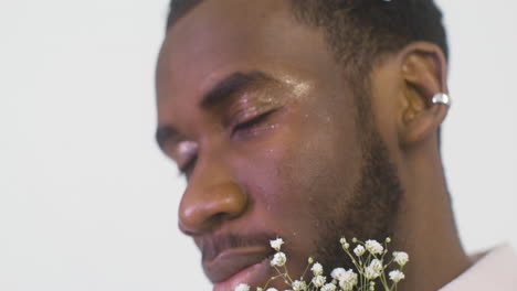 handsome man with little panicled babys' breath blowers in his hair