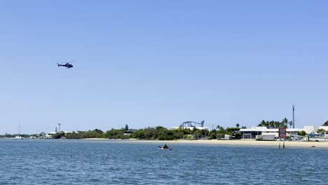 helicopter approaches and lands near marina