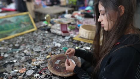 woman browsing jewelry at a flea market