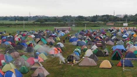 aerial view of multi-colored tents pitched in a field at a music festival