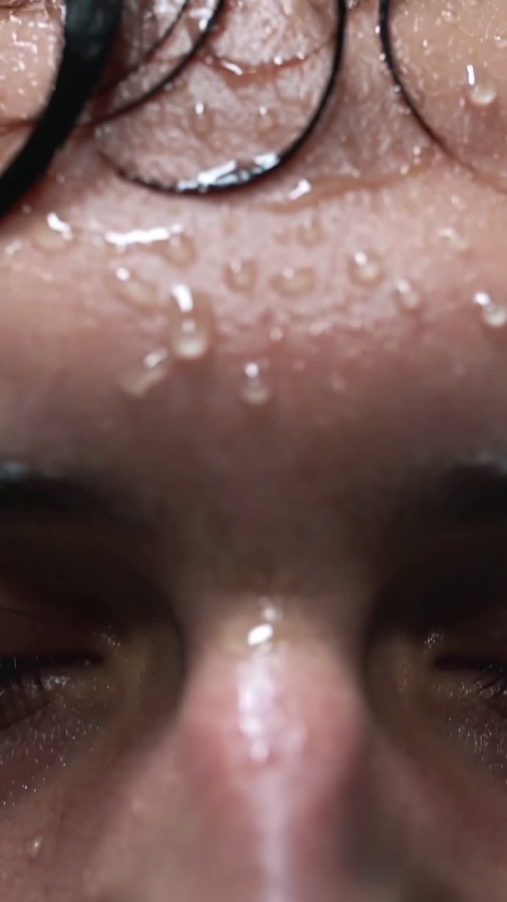 Close-up of Sweat Drops on a Person's Forehead