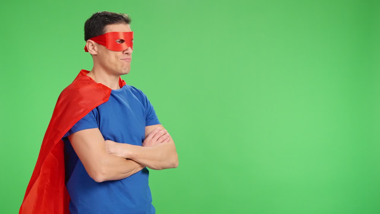 Superhero waiting with arms crossed on green screen