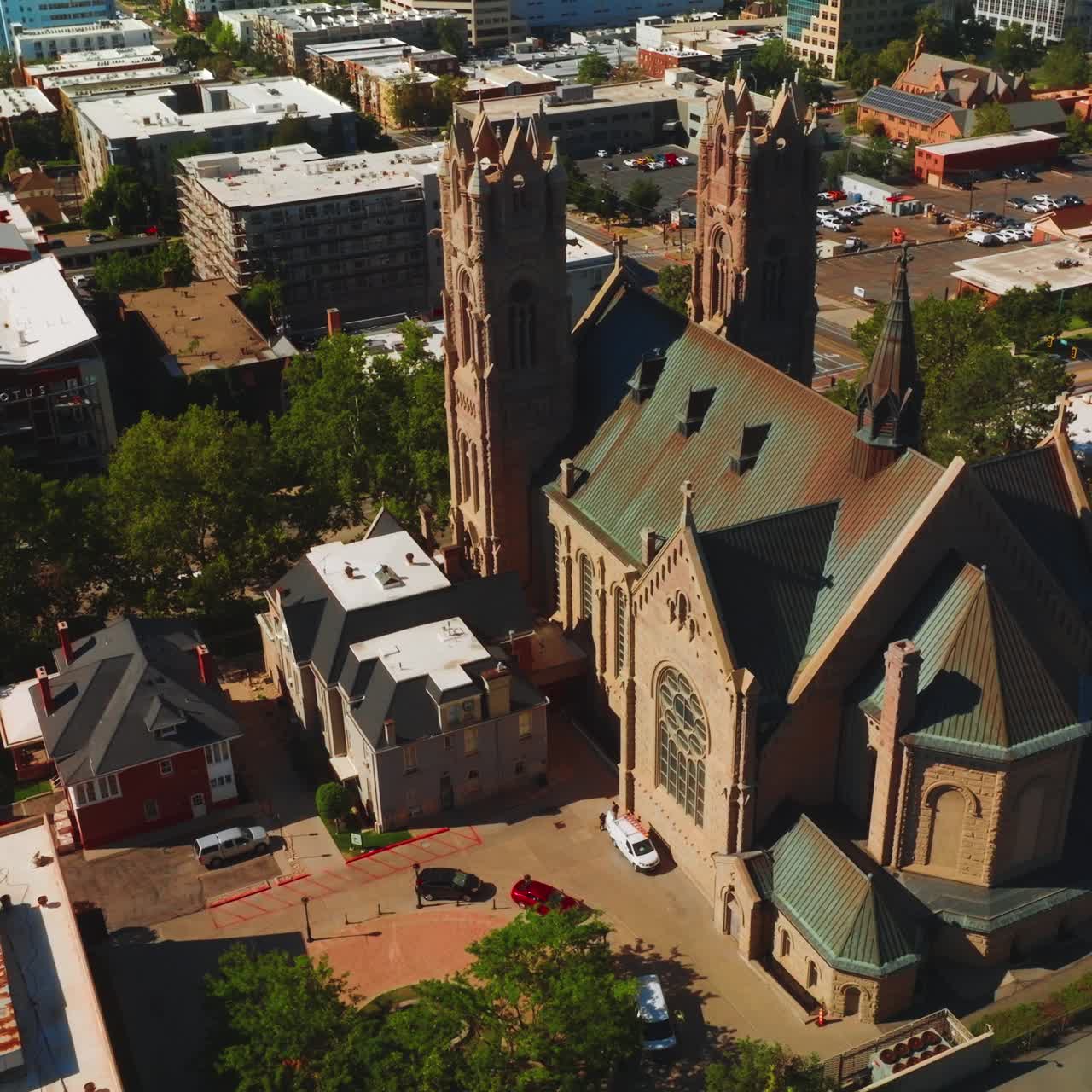 Magnificent building of Madeleine Cathedral among the urban architecture. Beautiful historic church of Salt Lake City from aerial perspective