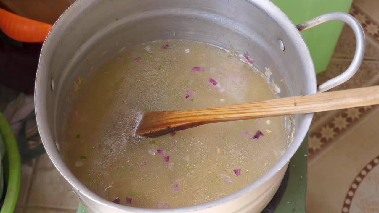 Yemeni Refugee in Ethiopia prepare rice meal in Addis Ababa, local homemade recipe pour water on rice