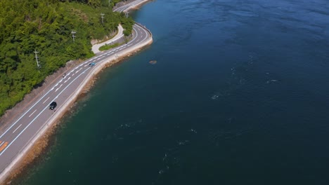 Aerial view of a scenic coastal road and bridge in Japan