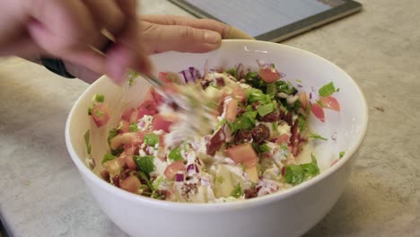 making a delicious cream cheese and tomato salad