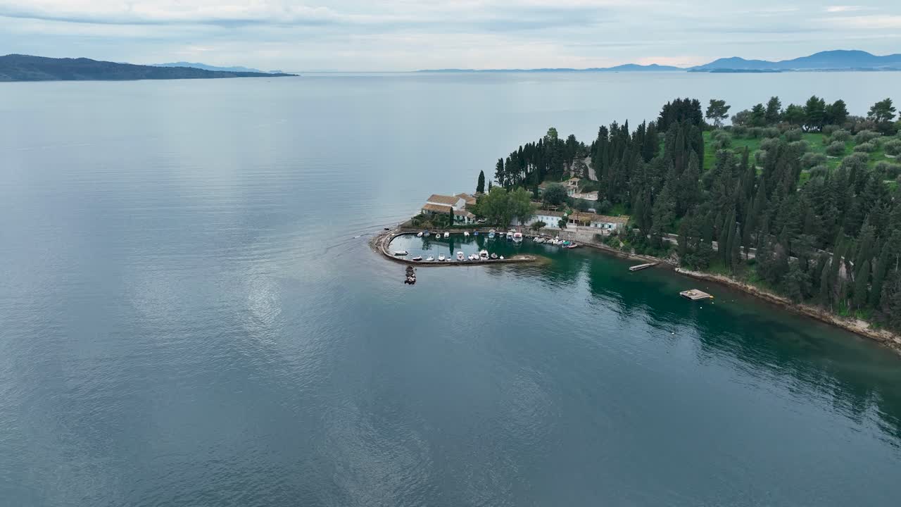Video di un drone del famoso porto e tenuta di Kouloura con cipressi e acqua turchese a Corfù, Grecia