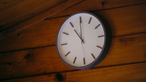 clock ticking at 11 oclock hanging in a wooden house