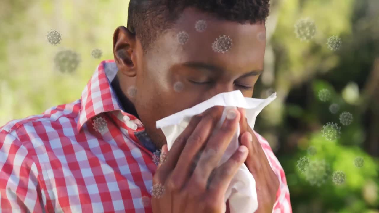 animación de células de covid-19 sobre un hombre enfermo soplando la nariz usando tejido