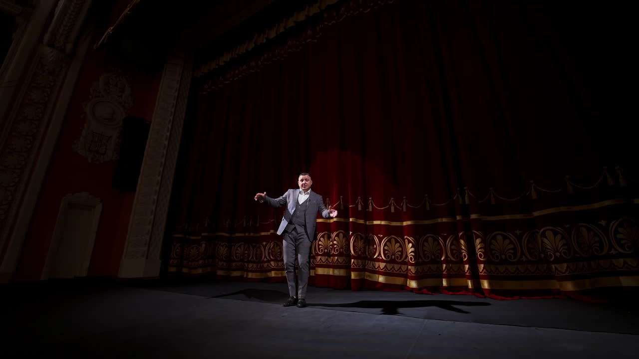 Motivational Speaker. Male actor on classic theatre stage.