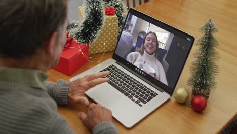 Hombre-Mayor-Caucásico-Teniendo-Videollamada-Navideña-En-Una-Computadora-Portátil-Con-Su-Nieta-Caucásica-En-La-Pantalla