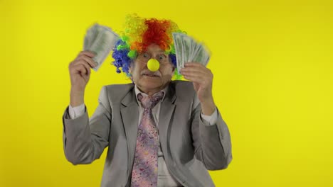 elderly clown businessman freelancer dancing with money dollar cash banknotes