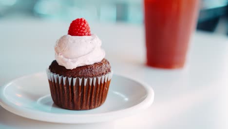 close up of cupcake on plate in coffee shop