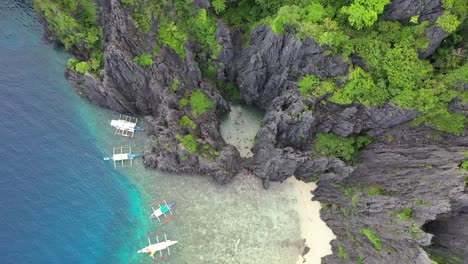 Aerial-view-of-beautiful-karst-scenery-and-turquoise-ocean-water-around-El-Nido,-Palawan,-Philippines