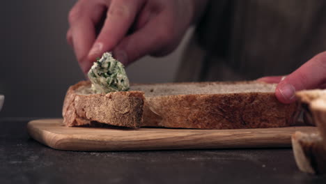 cu super slow motion female spreads green butter on bread. shot with high speed camera at 420 fps