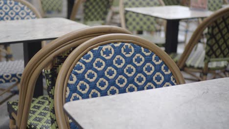 close-up of blue and white patterned cafe chairs with a marble table