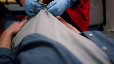 Close-up-view-of-male-doctor-preparing-victim-for-emergency-care