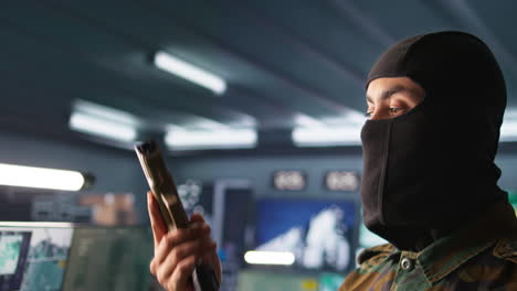 portrait of terrorist loading gun, attacking enemy command center, close up